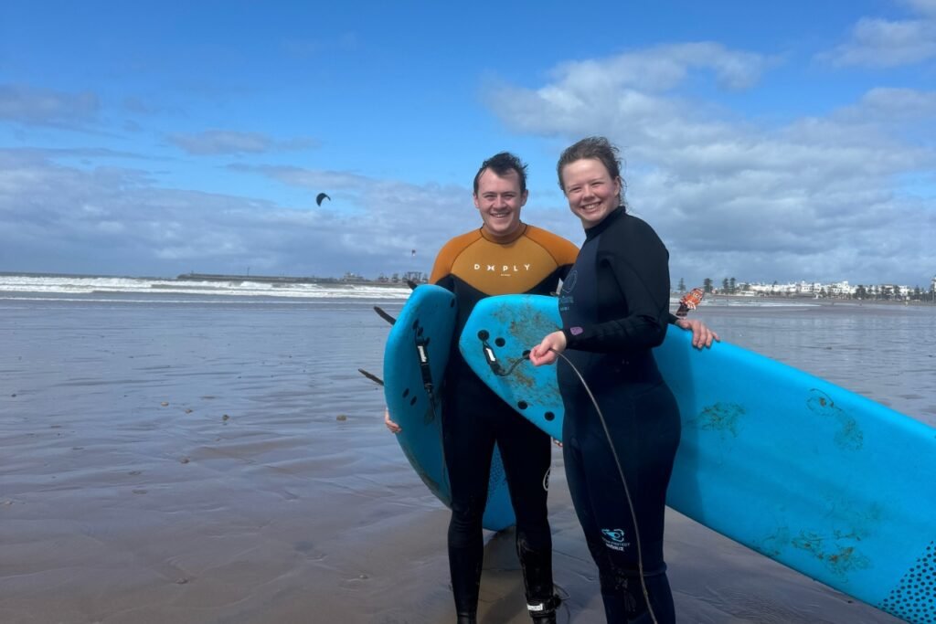 Two beginner surfers on Essaouira beach.